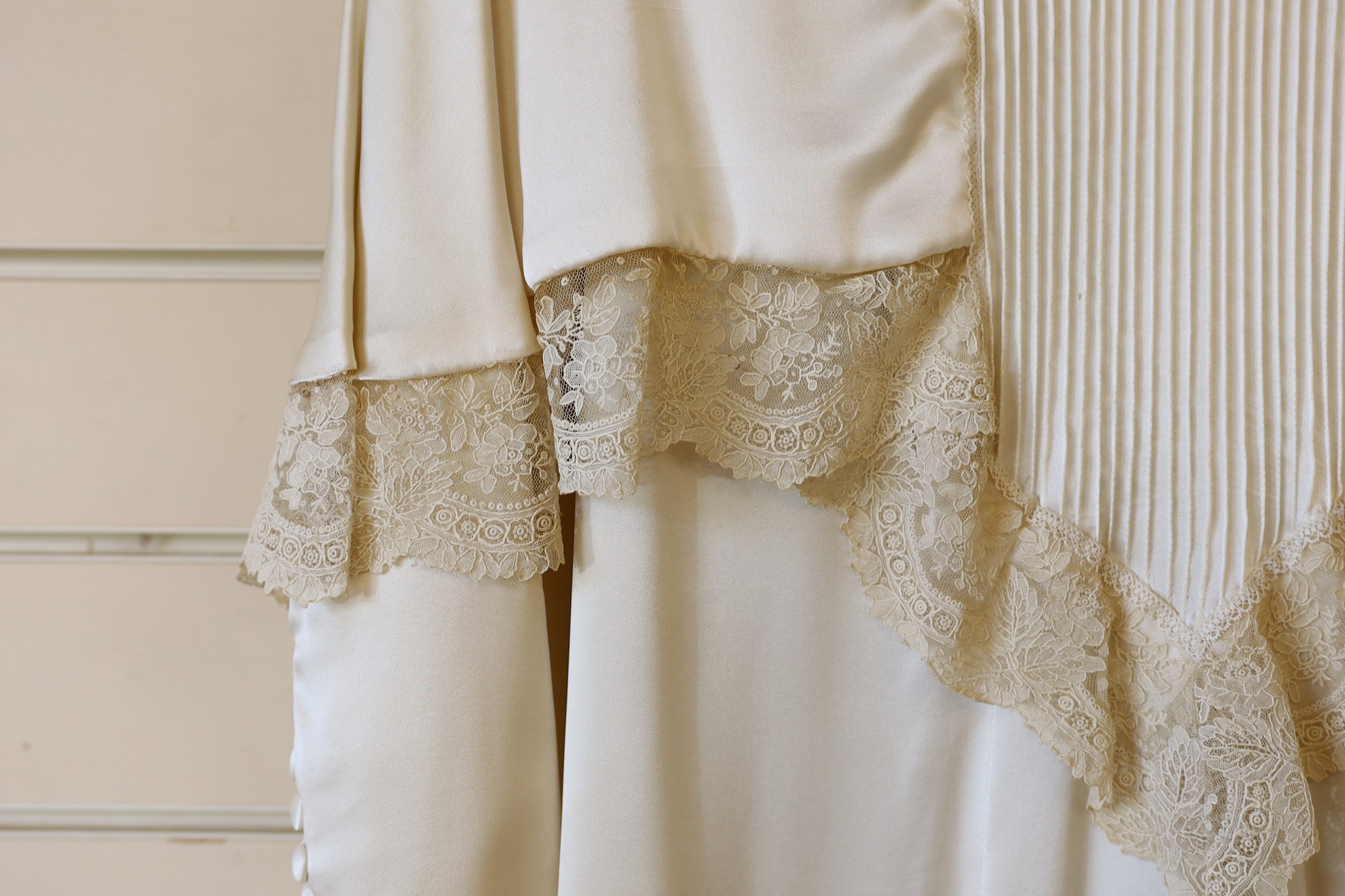 A 1970's cream satin wedding dress, trimmed with 19th century point de gaze, hand made needlepoint lace